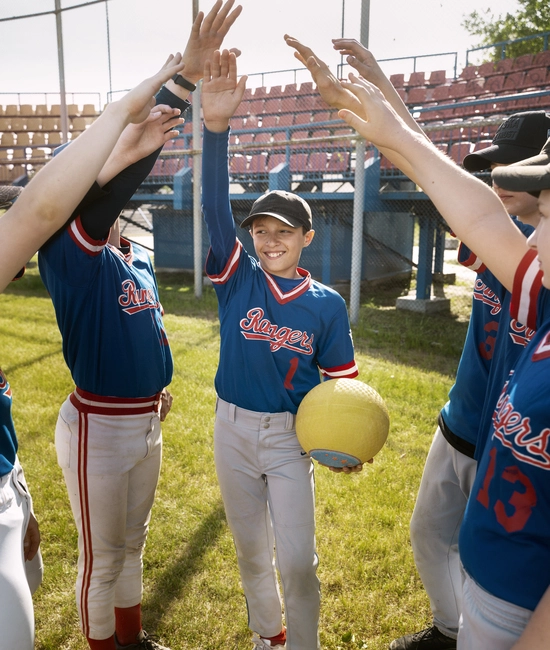 Children wearing custom made blue and white baseball uniform