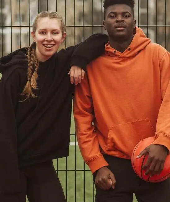 Couple wearing custom made hoodie made by farnix sports