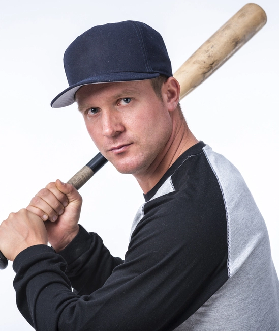 Side-view baseball player holding a bat