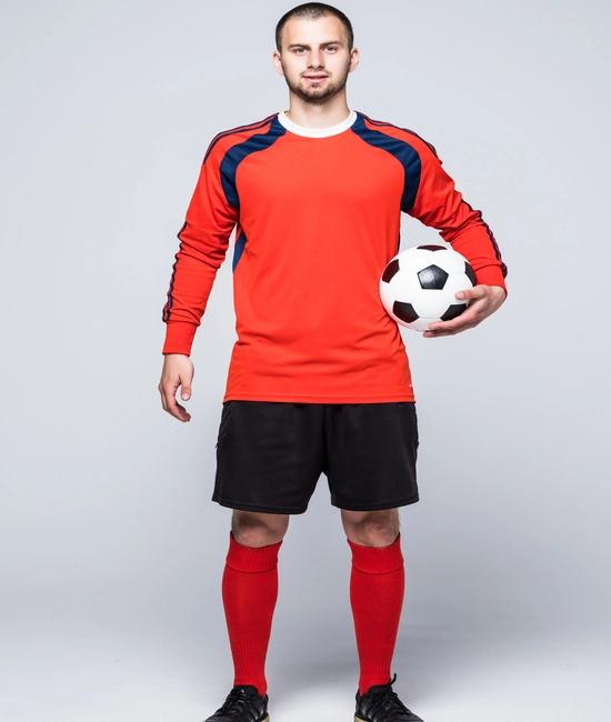 Young soccer player wearing custom made orange and black soccer uniform